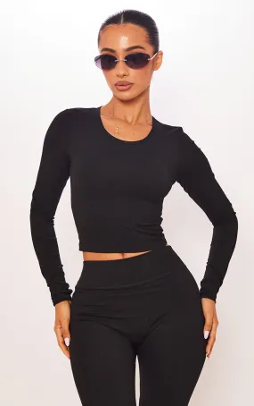 Petite Top Sculpt noir à contours et manches longues